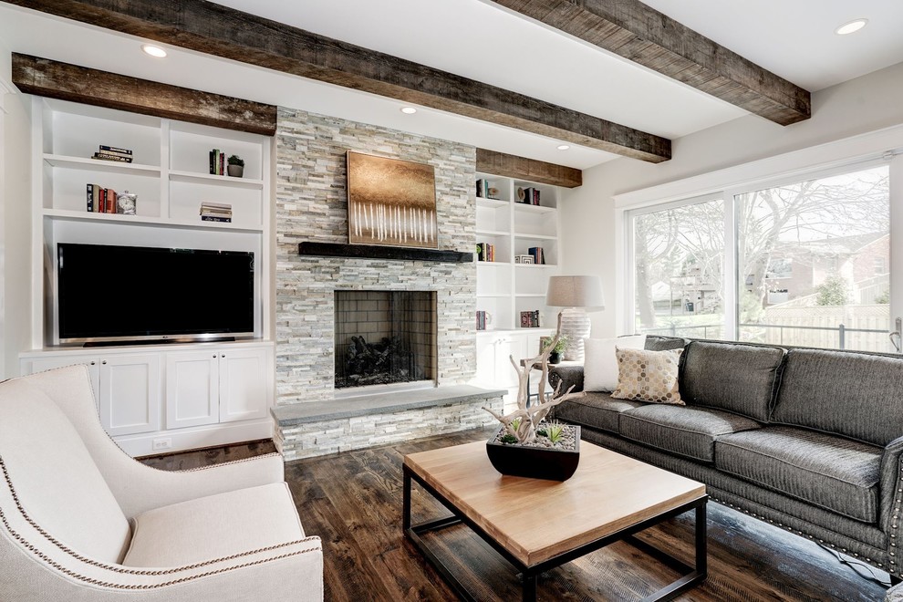 Design ideas for a large farmhouse open plan games room in DC Metro with grey walls, dark hardwood flooring, a standard fireplace, a stone fireplace surround, a freestanding tv and brown floors.