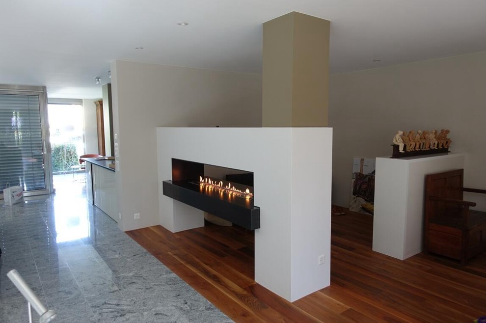 Inspiration for a large modern open concept plywood floor and yellow floor family room remodel in Other with a music area, white walls, a ribbon fireplace, a metal fireplace and a media wall
