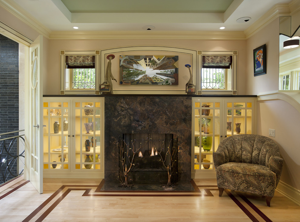 This is an example of a large eclectic open plan games room in Chicago with light hardwood flooring, a standard fireplace, a stone fireplace surround, multi-coloured floors and a concealed tv.