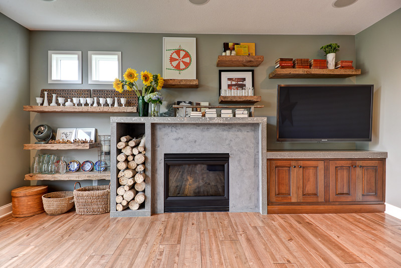 Inspiration for a large classic games room in Minneapolis with a reading nook, grey walls, medium hardwood flooring, a standard fireplace, a concrete fireplace surround and a wall mounted tv.