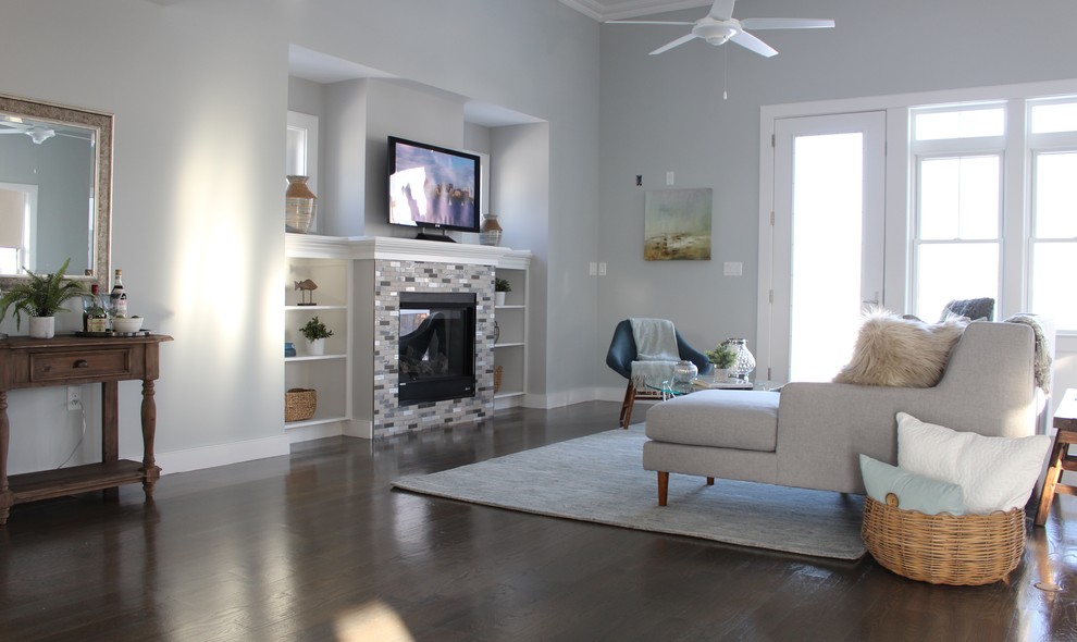 Large beach style open plan games room in Boston with blue walls, medium hardwood flooring, a tiled fireplace surround, a freestanding tv and brown floors.