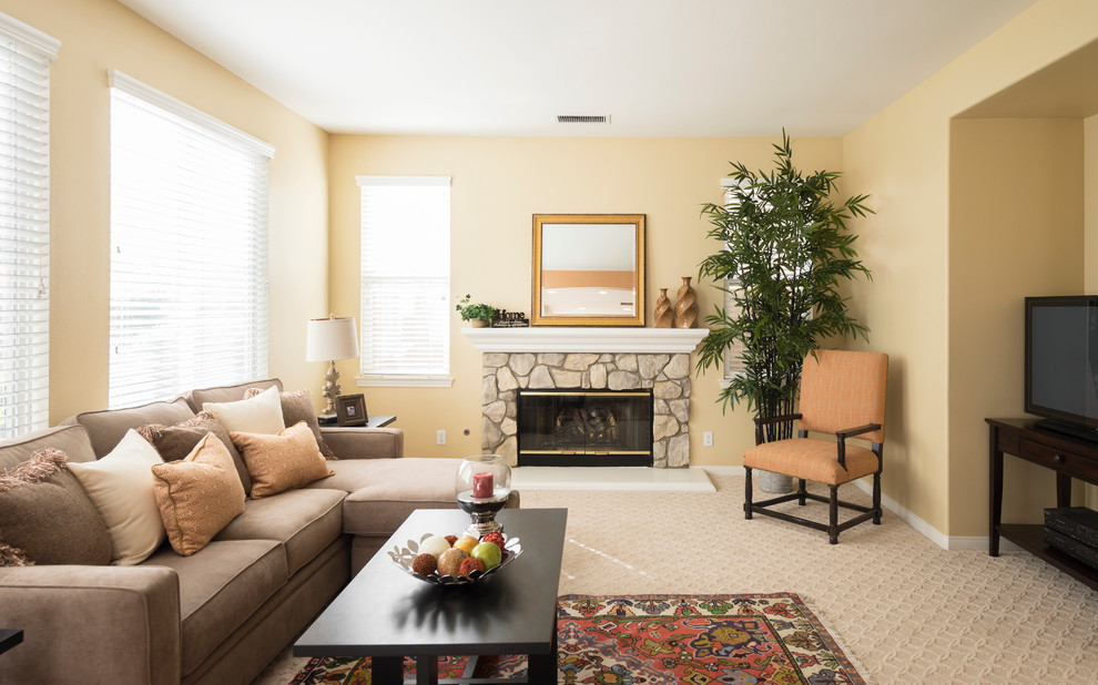 Transitional carpeted family room photo in Orange County with a stone fireplace