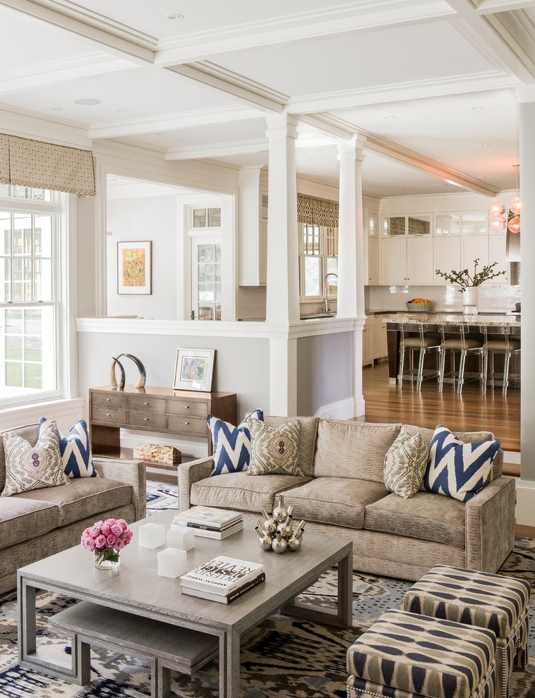 Example of a large transitional open concept medium tone wood floor and brown floor family room design in Boston with gray walls and no tv
