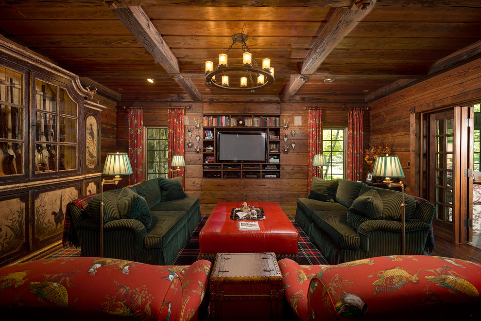 Example of a mountain style enclosed family room library design in Detroit with a media wall