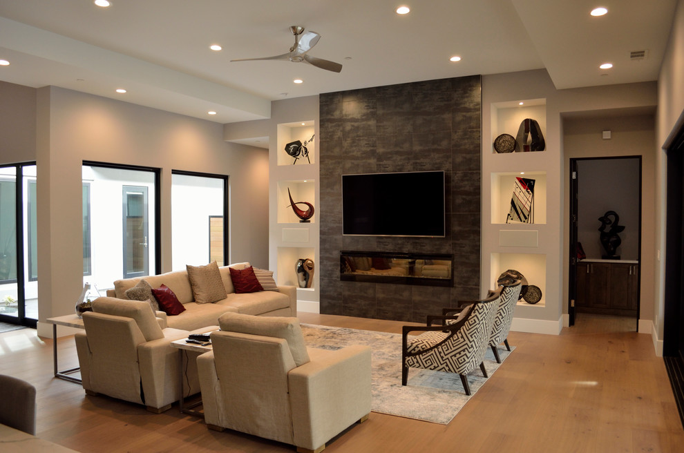 Example of a mid-sized trendy open concept light wood floor and beige floor family room design in Sacramento with white walls, a ribbon fireplace, a concrete fireplace and a wall-mounted tv