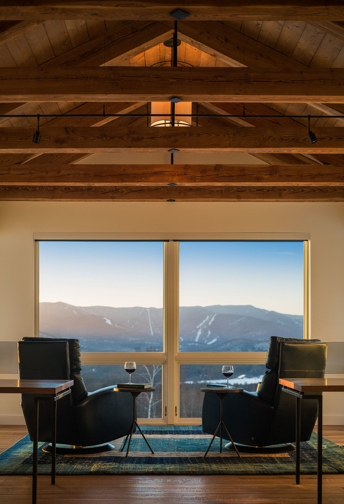 Example of a mountain style family room design in Burlington with white walls