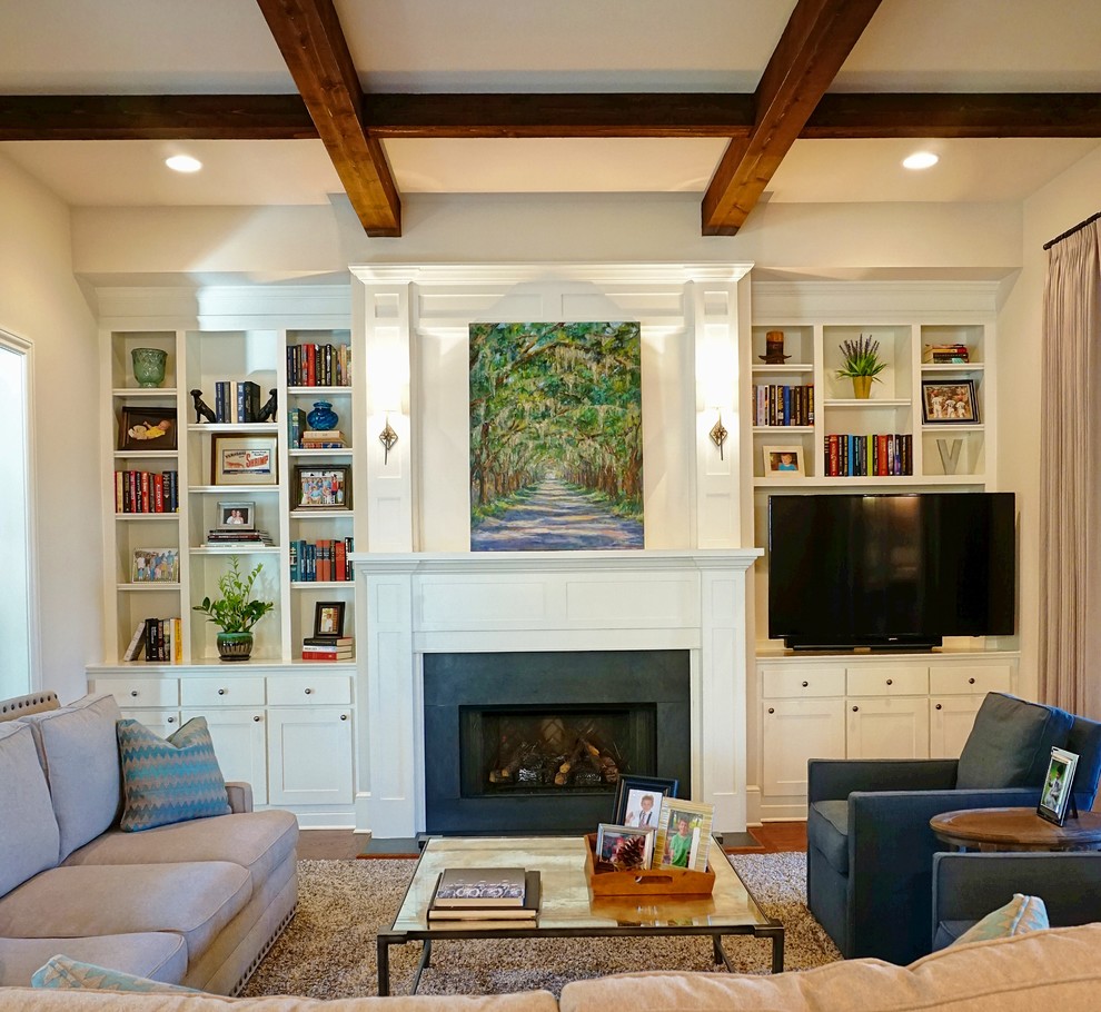 Mid-sized transitional open concept medium tone wood floor family room library photo in Charlotte with a tv stand, white walls, a standard fireplace and a wood fireplace surround