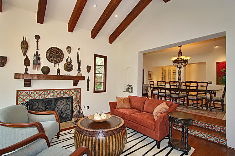 Large tuscan enclosed dark wood floor and brown floor family room photo in San Diego with a music area, white walls, a standard fireplace, a tile fireplace and no tv