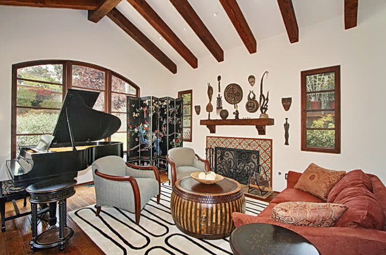 Large tuscan enclosed dark wood floor and brown floor family room photo in San Diego with a music area, white walls, a standard fireplace, a tile fireplace and no tv
