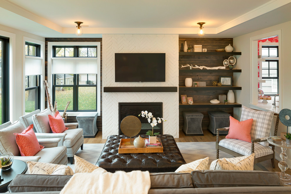 Свежая идея для дизайна: гостиная комната в стиле неоклассика (современная классика) с паркетным полом среднего тона, стандартным камином и телевизором на стене - отличное фото интерьера