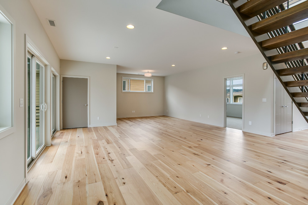 Inspiration for a contemporary games room in Seattle with light hardwood flooring, white walls and beige floors.