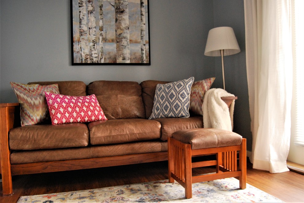 Ejemplo de sala de estar cerrada actual pequeña con paredes azules, suelo vinílico, televisor independiente y suelo marrón