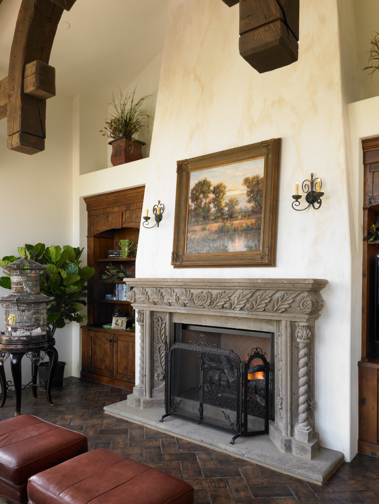 Photo of a large mediterranean open plan games room in Denver with white walls, a standard fireplace, a stone fireplace surround and a built-in media unit.