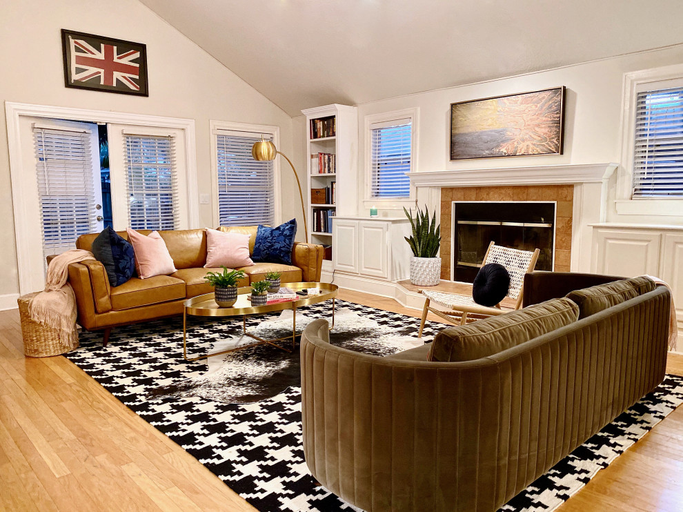 Large eclectic enclosed light wood floor and beige floor family room photo in Tampa with white walls, a standard fireplace, a tile fireplace and a tv stand