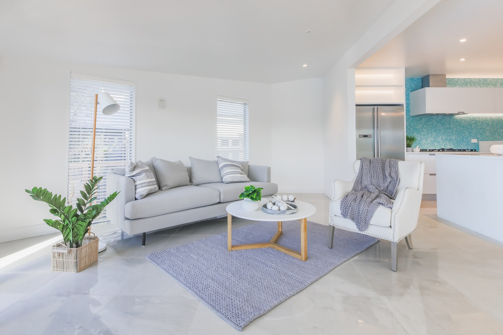 Mid-sized beach style open concept marble floor and white floor family room photo in Wellington with white walls, no fireplace and no tv