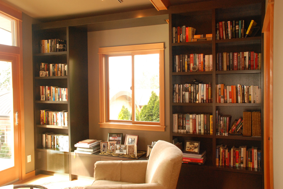 Inspiration for a transitional carpeted family room library remodel in Seattle with brown walls