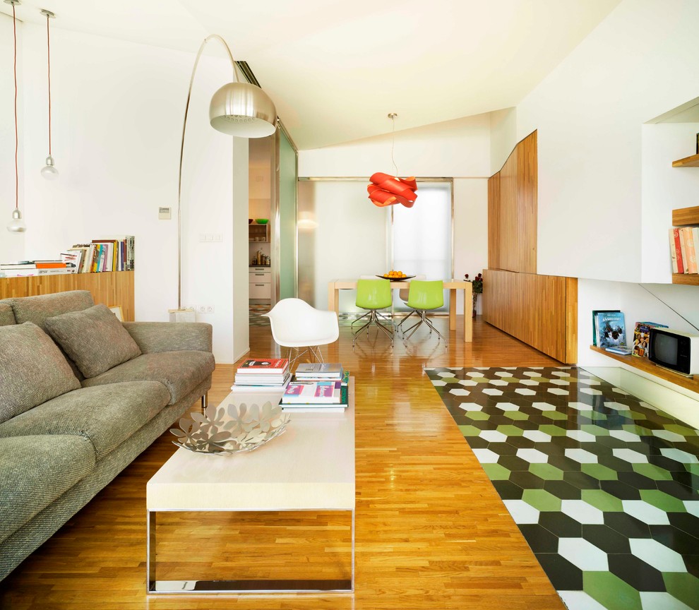 Large contemporary open plan living room in Alicante-Costa Blanca with white walls, light hardwood flooring, a freestanding tv and no fireplace.