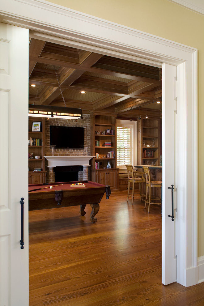Photo of a medium sized contemporary open plan games room in Atlanta with a game room, medium hardwood flooring, a standard fireplace, a brick fireplace surround and a wall mounted tv.