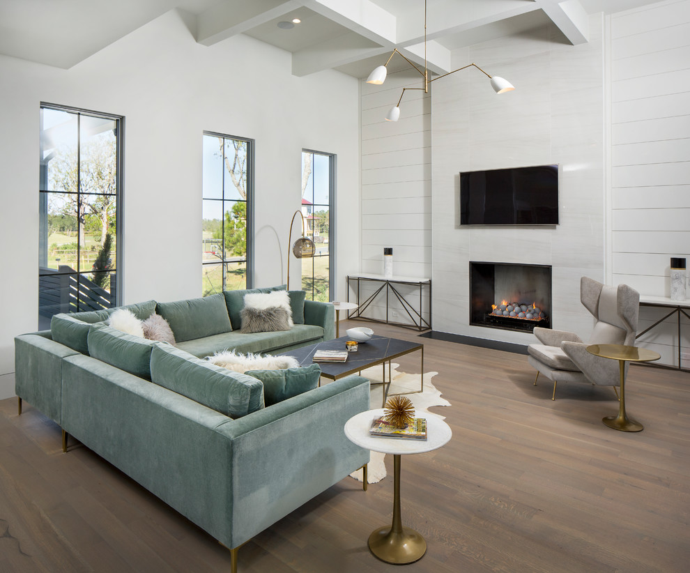 Large trendy open concept medium tone wood floor and gray floor family room photo in Charleston with white walls, a standard fireplace and a metal fireplace
