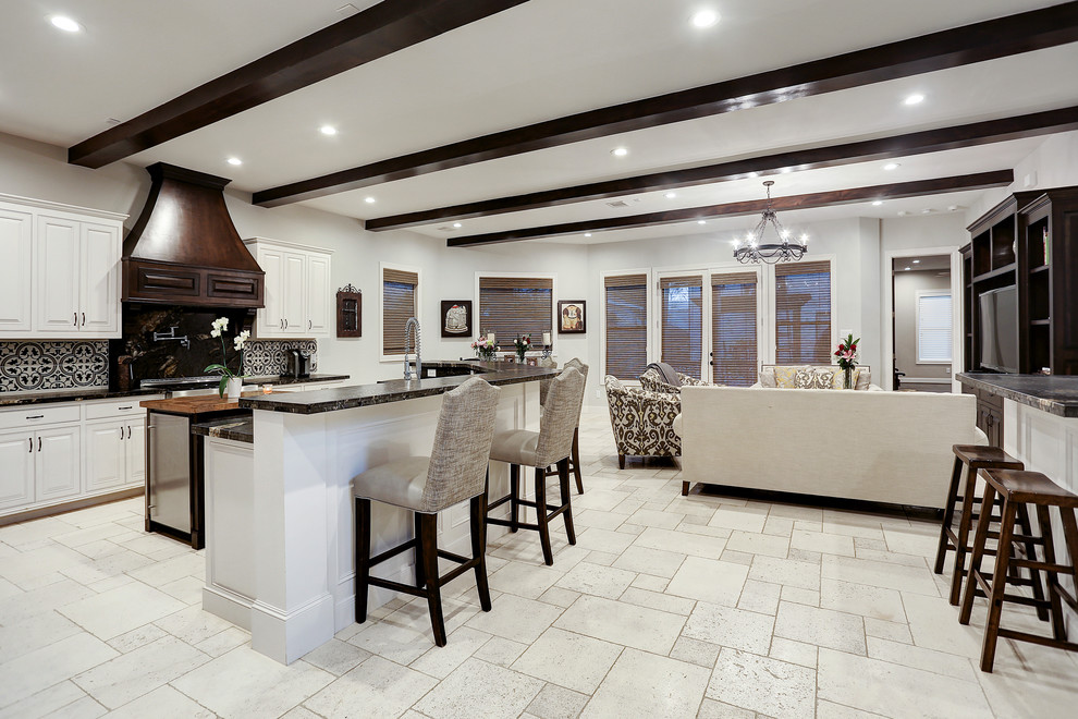 Example of a large tuscan open concept limestone floor and white floor family room design in Houston with white walls, no fireplace and a tv stand