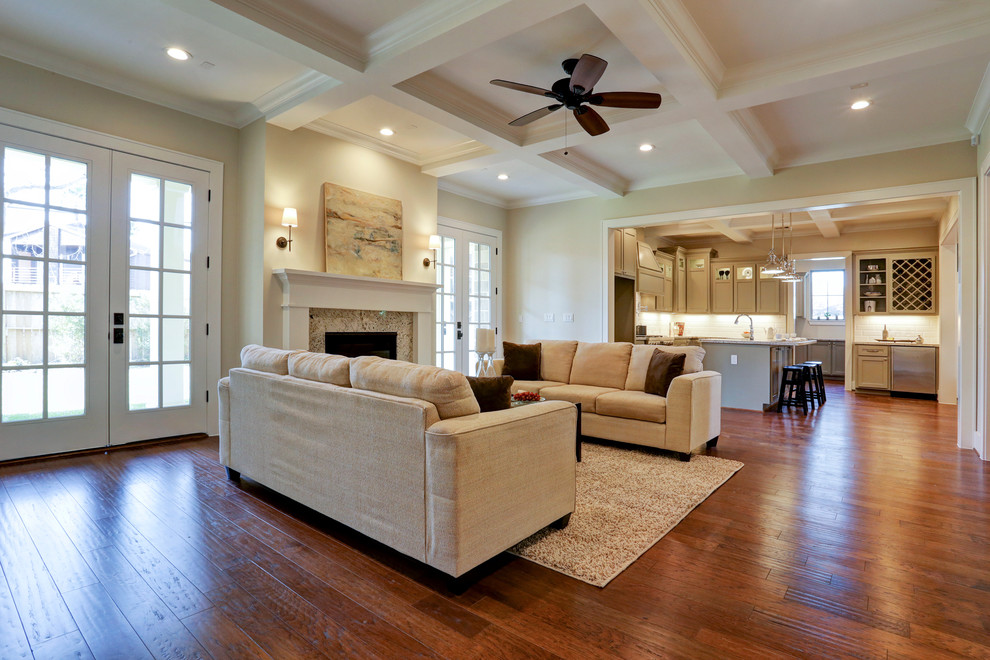 Photo of a large traditional open plan games room in Houston with beige walls, medium hardwood flooring, a standard fireplace, a stone fireplace surround and a wall mounted tv.