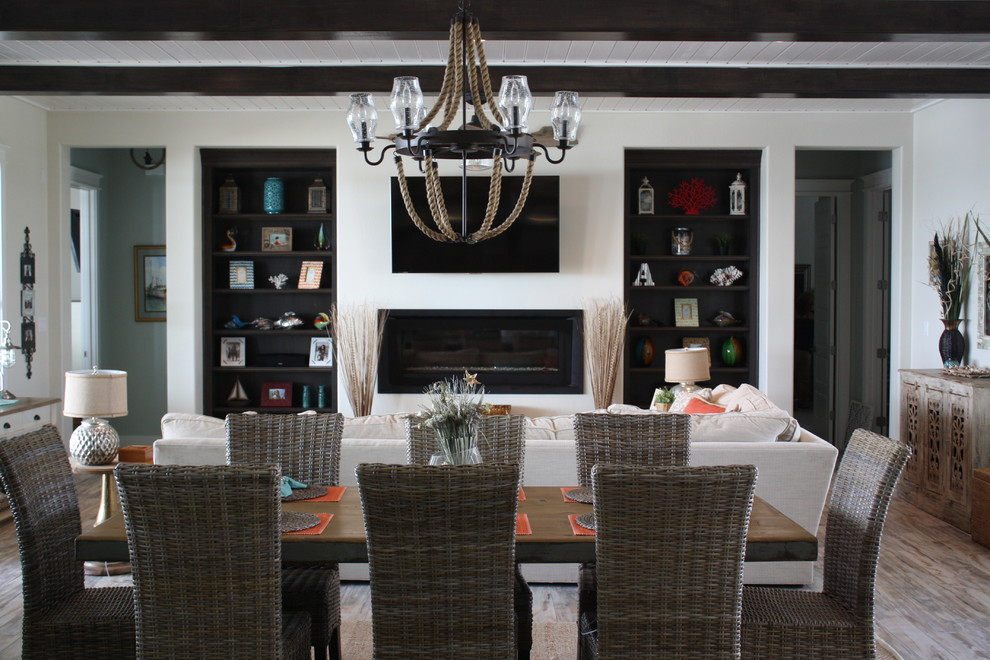 This is an example of a medium sized coastal dining room in Houston with white walls, porcelain flooring and a ribbon fireplace.