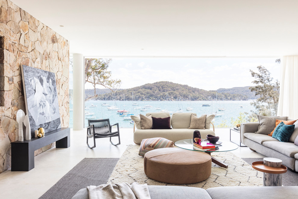 Example of a beach style white floor family room design in Sydney with white walls
