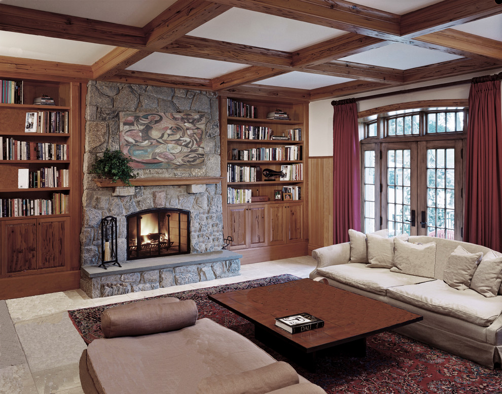 Idée de décoration pour une salle de séjour craftsman de taille moyenne et ouverte avec une bibliothèque ou un coin lecture, un mur blanc, une cheminée standard et un manteau de cheminée en pierre.