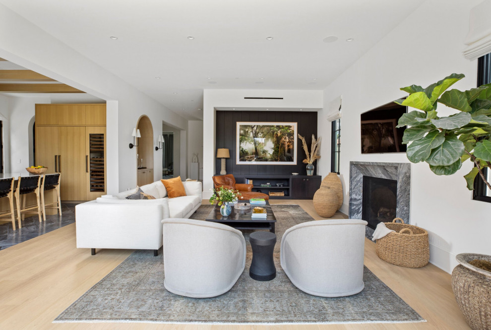 Inspiration for a large transitional open concept light wood floor, beige floor and coffered ceiling family room remodel in Los Angeles with white walls, a standard fireplace, a stone fireplace and a wall-mounted tv