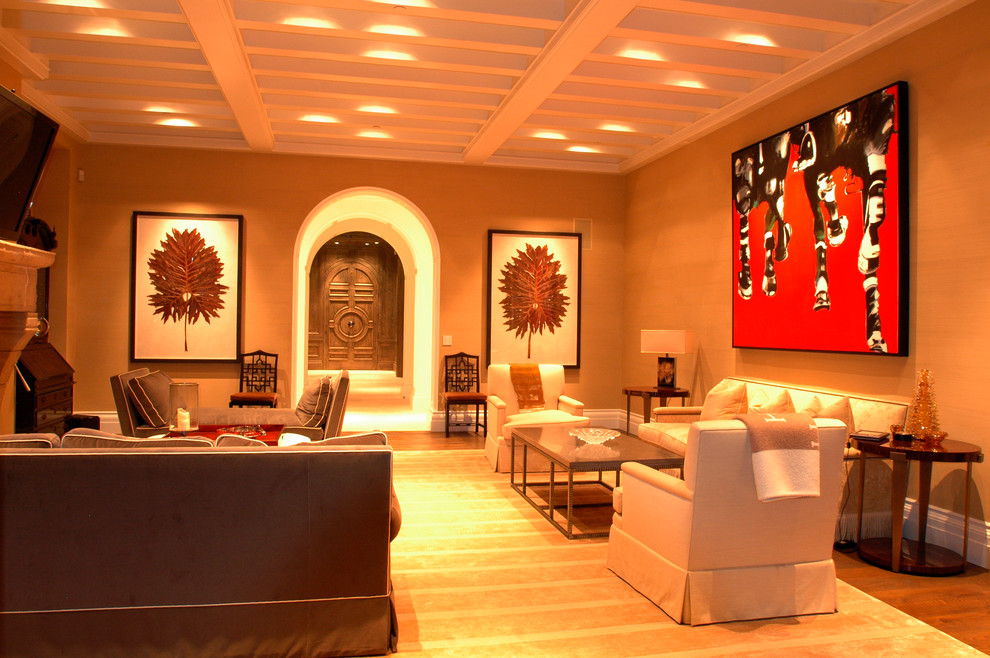 На фото: большая изолированная гостиная комната в стиле неоклассика (современная классика) с коричневыми стенами, паркетным полом среднего тона, стандартным камином и фасадом камина из камня