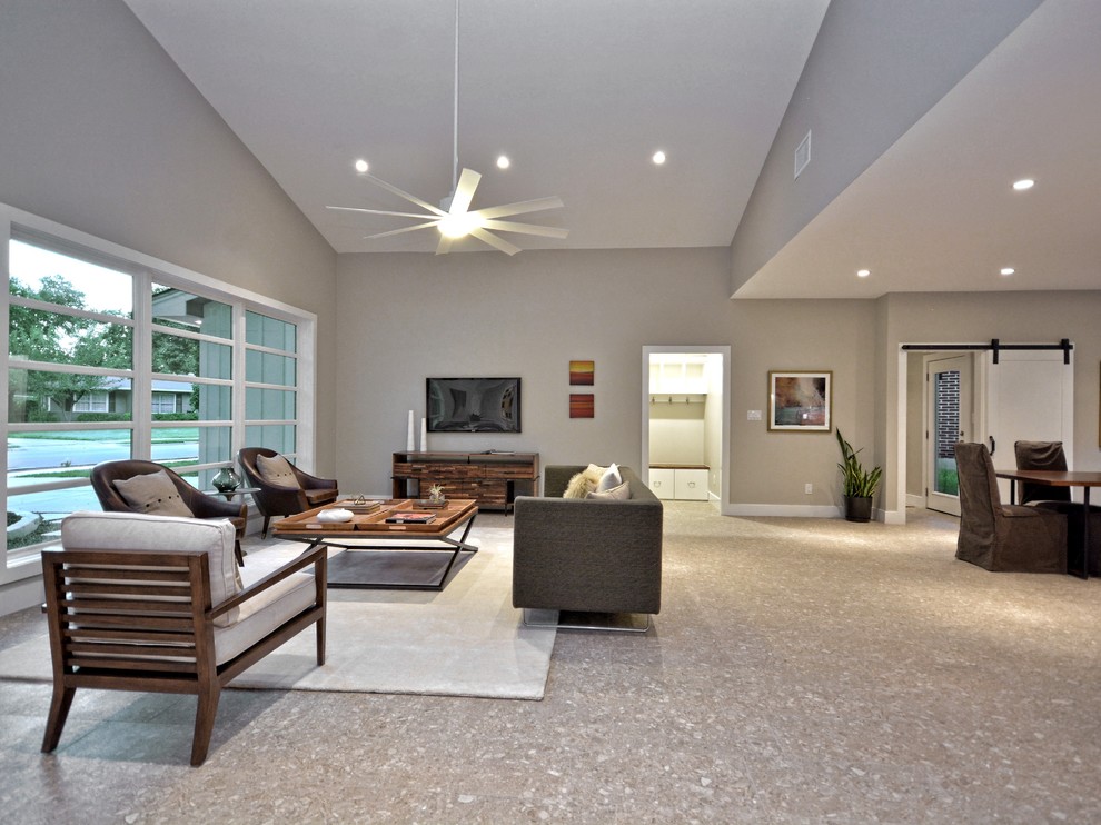 Inspiration for a large 1960s open concept porcelain tile family room remodel in Austin with gray walls and no tv