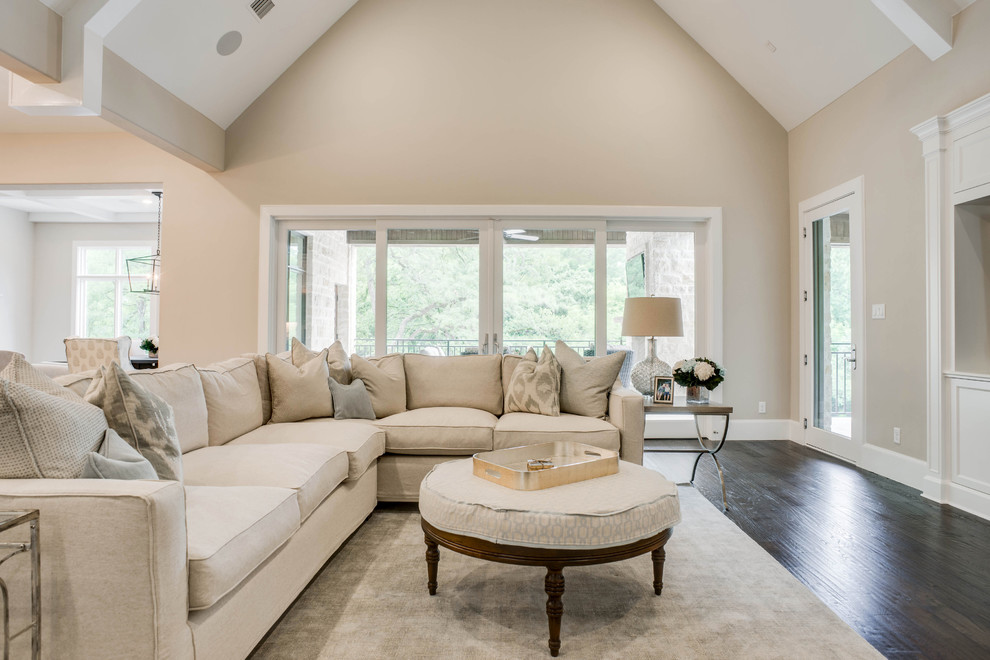 Large transitional open concept medium tone wood floor and brown floor family room photo in Dallas with gray walls and a standard fireplace