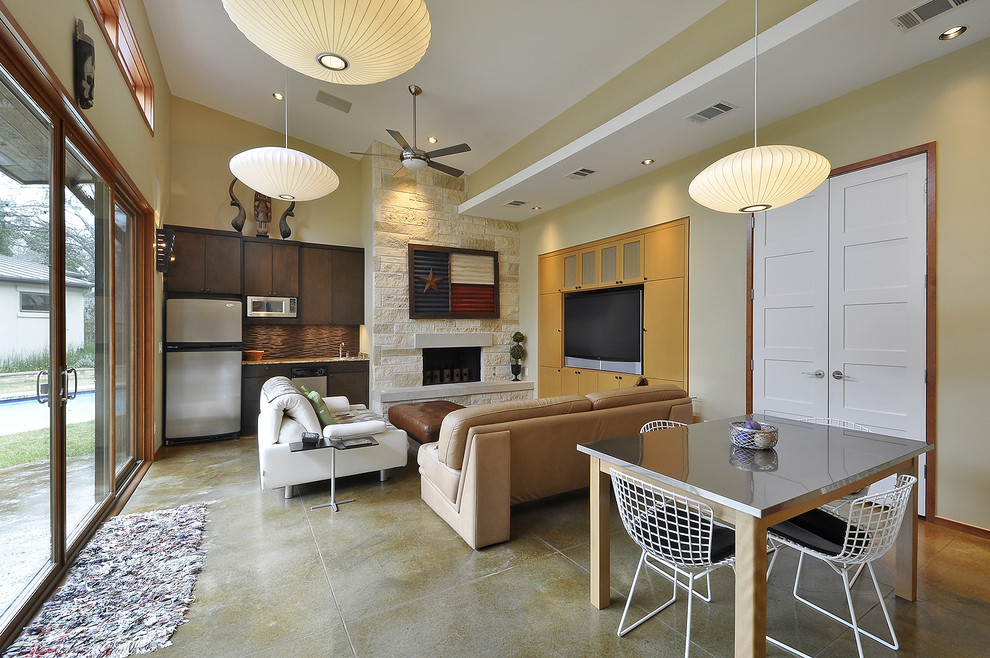 Inspiration for a contemporary concrete floor family room remodel in Austin with a stone fireplace