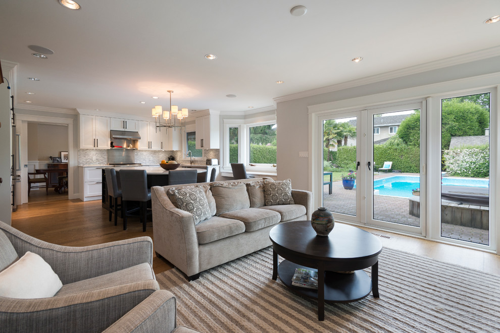 Games room in Vancouver with grey walls, light hardwood flooring, a standard fireplace, a stone fireplace surround and a built-in media unit.