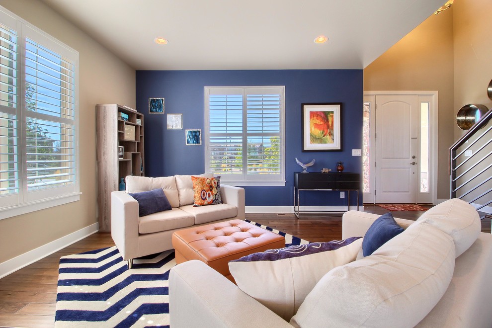 Inspiration for a mid-sized transitional open concept brown floor and dark wood floor family room remodel in Denver with blue walls, no fireplace and no tv