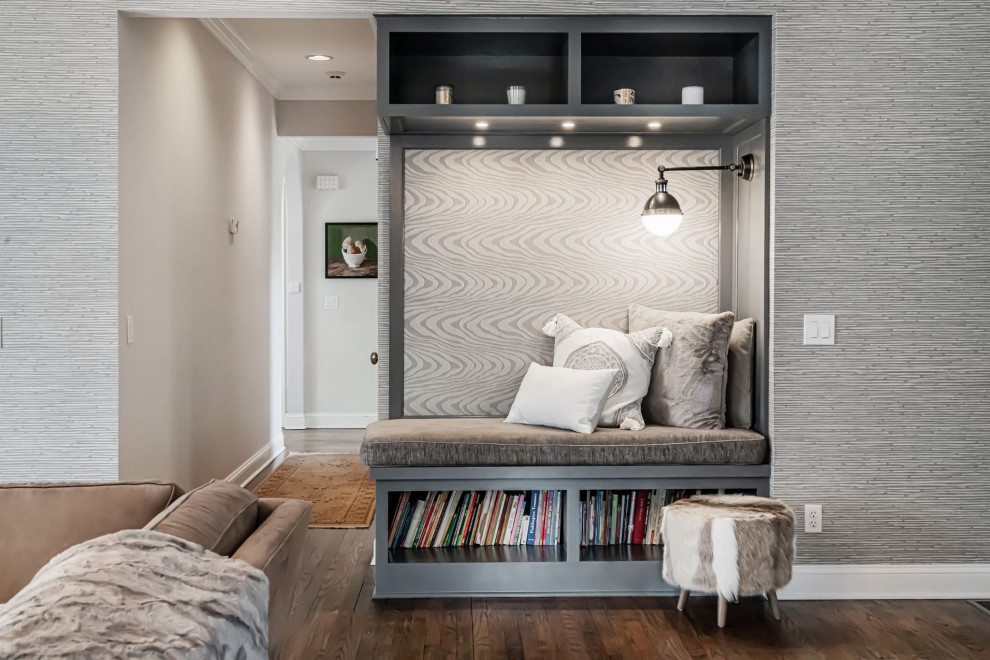 Large transitional open concept medium tone wood floor, brown floor and wallpaper family room library photo in New York with gray walls