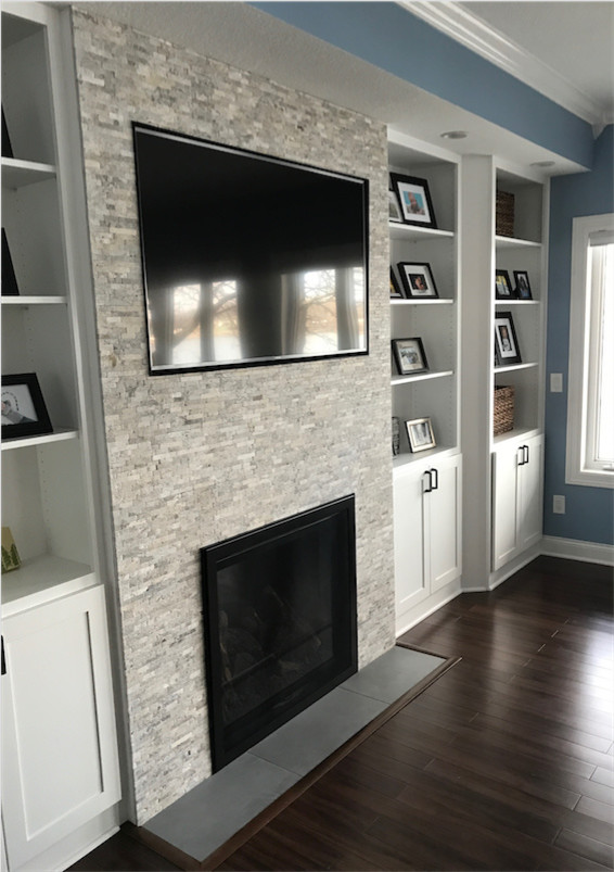 Photo of a medium sized contemporary open plan games room in Other with blue walls, dark hardwood flooring, a standard fireplace, a stone fireplace surround and a built-in media unit.
