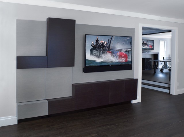 Inspiration for a large contemporary games room in New York with dark hardwood flooring.