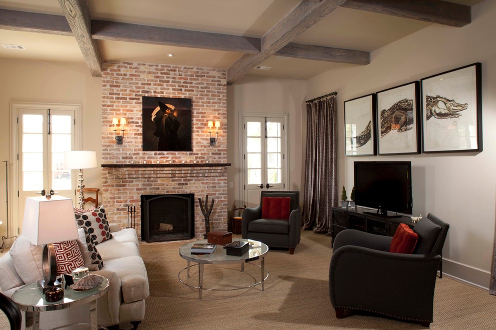 Idée de décoration pour une très grande salle de séjour tradition ouverte avec un mur beige, une cheminée standard, un manteau de cheminée en brique et poutres apparentes.