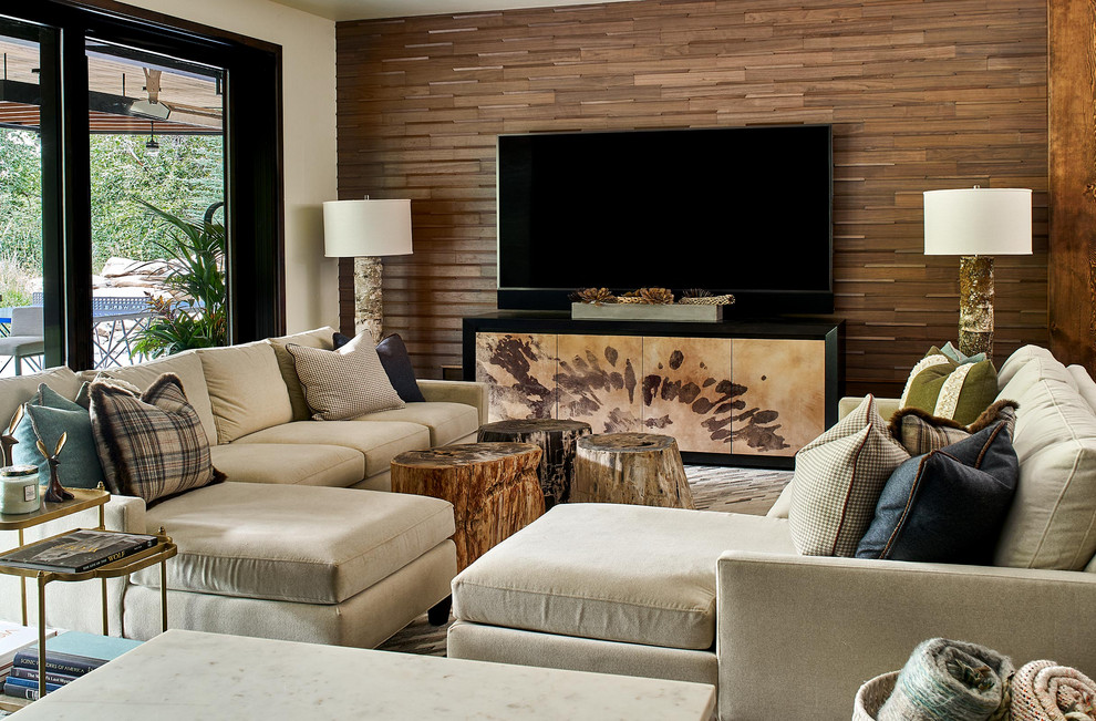 Large rustic games room in Denver with brown walls, no fireplace, a wall mounted tv, wood walls and a feature wall.