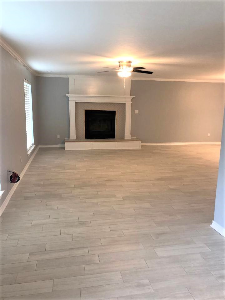 Inspiration for a medium sized classic open plan games room in Dallas with grey walls, ceramic flooring, a standard fireplace, a tiled fireplace surround and grey floors.