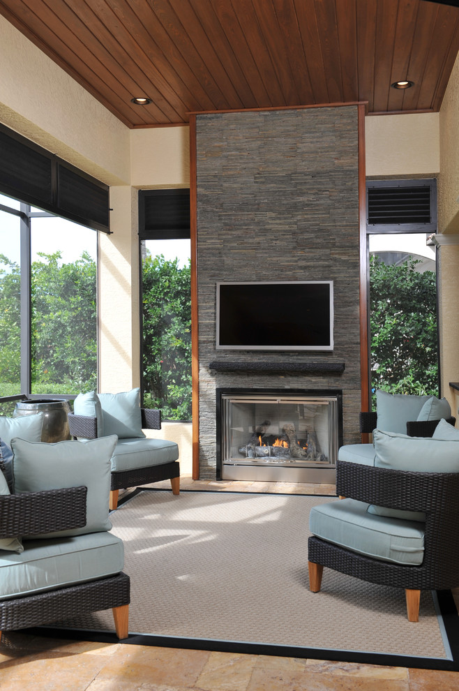 Example of a trendy open concept beige floor family room design in Miami with a standard fireplace, a stone fireplace and a media wall