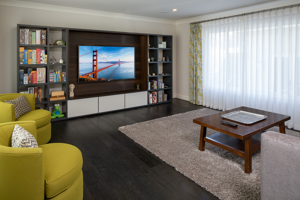 Mid-sized trendy open concept dark wood floor and black floor family room photo in Los Angeles with a media wall, gray walls and no fireplace