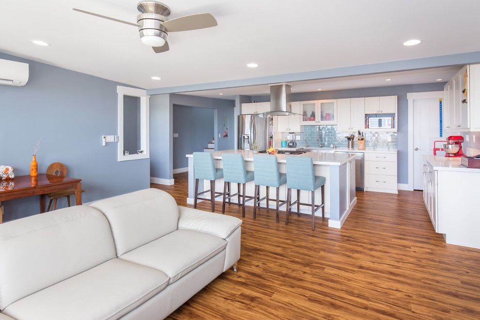 Large transitional open concept light wood floor family room photo in Hawaii with blue walls, no fireplace and a tv stand