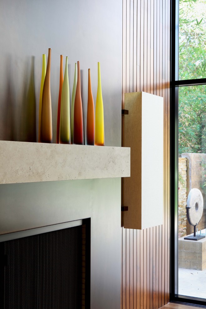 Inspiration for a contemporary family room remodel in Los Angeles with a standard fireplace