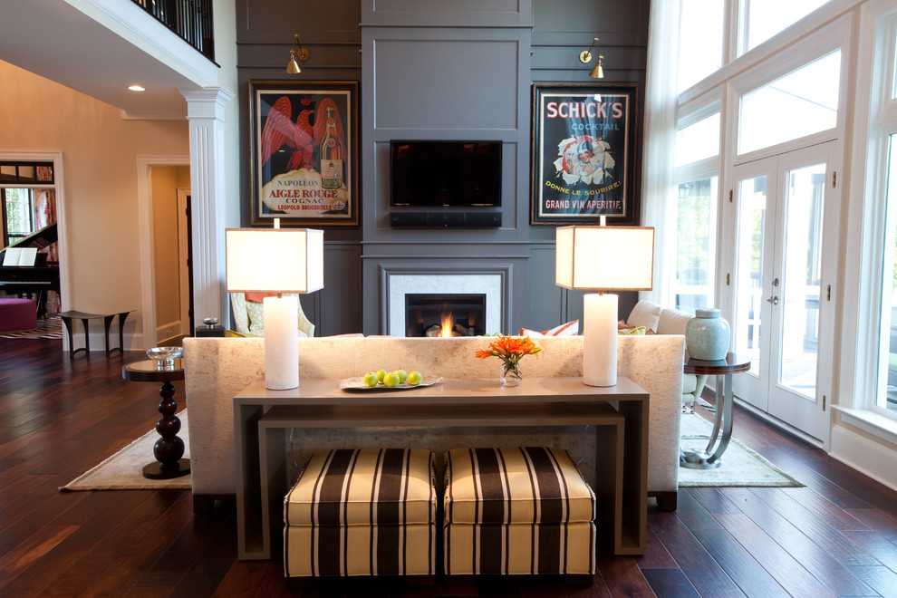 Inspiration for a classic open plan games room in Baltimore with grey walls, dark hardwood flooring, a standard fireplace, a wall mounted tv and feature lighting.