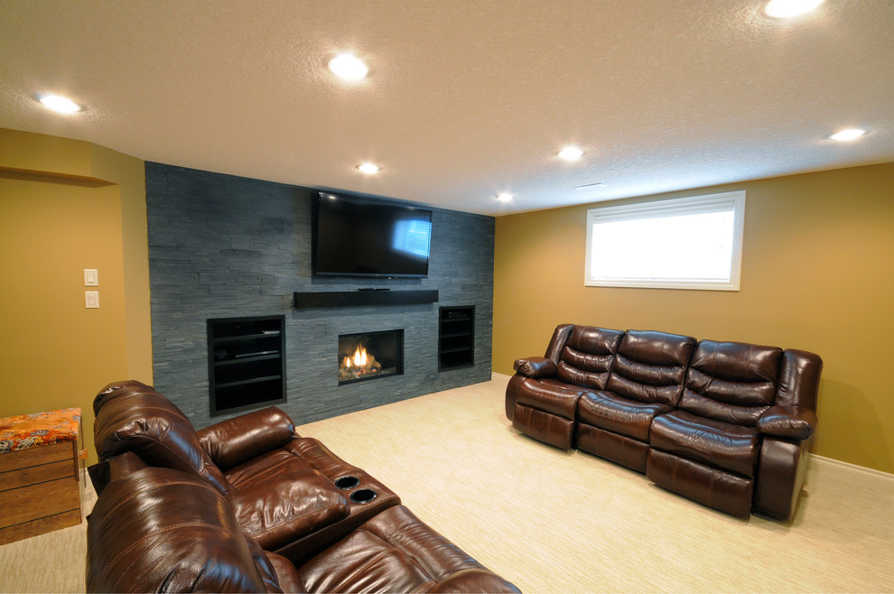 Photo of an expansive contemporary open plan games room in Calgary with a reading nook, yellow walls, a standard fireplace, a stone fireplace surround, a wall mounted tv and light hardwood flooring.