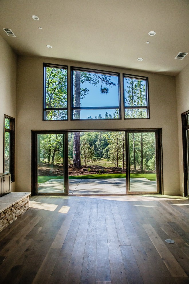 Inspiration for a mid-sized contemporary enclosed dark wood floor and brown floor family room remodel in Sacramento with beige walls