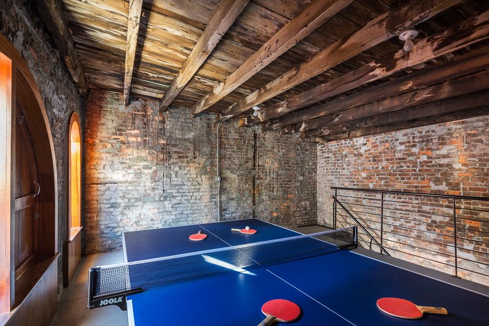 Large urban games room in New York with brown walls.