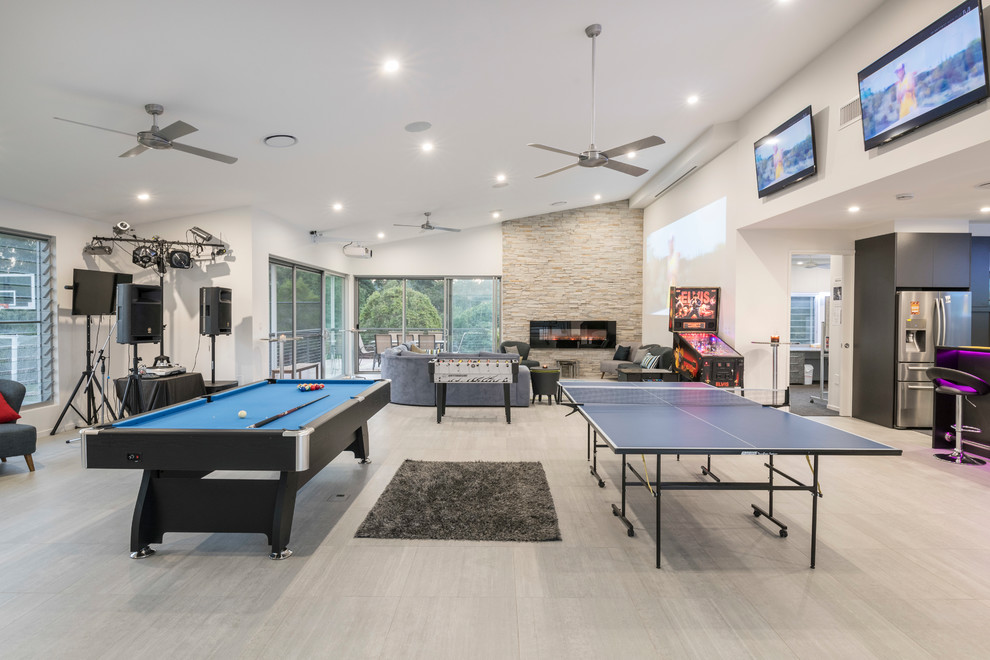 Design ideas for a contemporary open plan games room in Brisbane with white walls, light hardwood flooring, a ribbon fireplace, a metal fireplace surround, a wall mounted tv and beige floors.